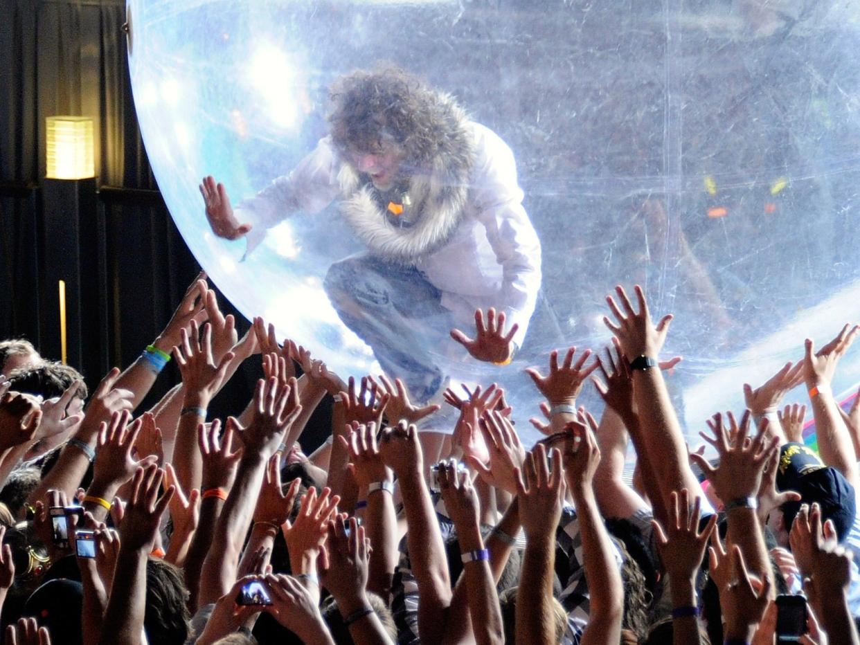 The Flaming Lips performing with a bubble in 2011. Unlike their recent concert, the audience were not given bubbles of their own (Getty)