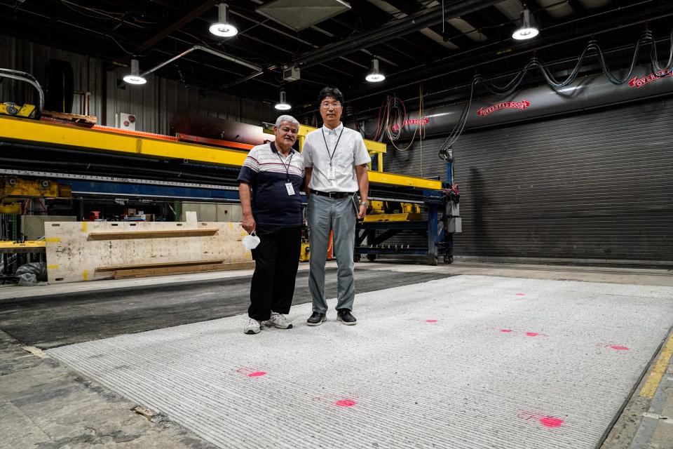 From left, Samy Noureldin and Jusang Lee, from the Indiana Dept. of Transportation Division of Research stand on a concrete pad and asphalt pad used for testing electric car charging, during a media tour on Thursday, June 16, 2022, at the Indiana Dept. of Transportation Division of Research in West Lafayette, Ind. 