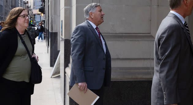 Adams County Judge Robert Adrian (center) heads into an Illinois Courts Commission hearing on Nov. 7 in Chicago. The commission removed Adrian from the bench on Friday, concluding he engaged in misconduct when he reversed an 18-year-old's rape conviction.