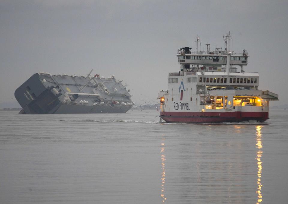 The cargo ship Hoegh Osaka lies on its side after being deliberately ran aground on the Bramble Bank in the Solent estuary near Southampton