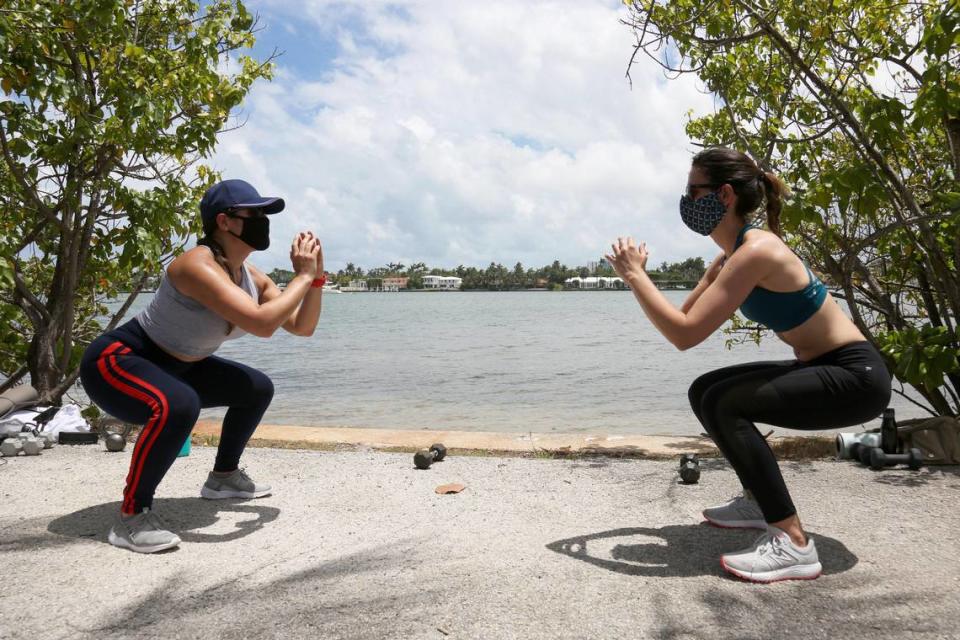 Jessica Smith, left, and Lauren Naples work out by the Julia Tuttle Causeway Saturday.