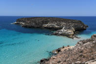 A view of the Rabbits Island, surrounded by Cristal clear waters, just next to the Island of Lampedusa, southern Italy, Friday, May 14, 2021. Lampedusa is closer to Africa than the Italian mainland, and it has long been the destination of choice for migrant smuggling operations leaving Libya. Over the years, it has witnessed countless numbers of shipwrecks and seen bodies floating offshore, only to be buried in the cemetery on land. (AP Photo/Salvatore Cavalli)