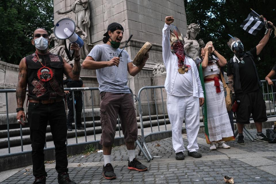 NEW YORK, NY - JUNE 30: A traditional Taino tribe song is performed as members of the The Indigenous People's Day New York City Committee held a Circle of Belonging in Columbus Circle on June 30, 2020 in New York City. The group's long-term goal to remove the statue at Columbus Circle and change Columbus Day to Indigenous People's Day has been reignited by the current protests against racism. (Photo by Byron Smith/Getty Images)