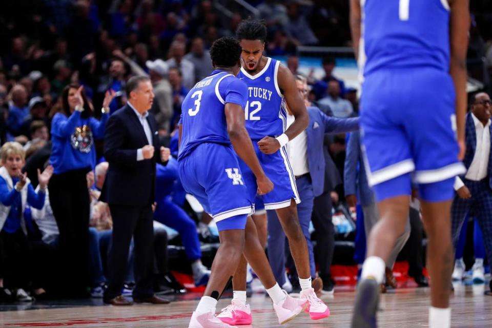 Kentucky’s Antonio Reeves (12) reacts after making a 3-pointer in the first half against Kansas in the Champions Classic in Chicago.