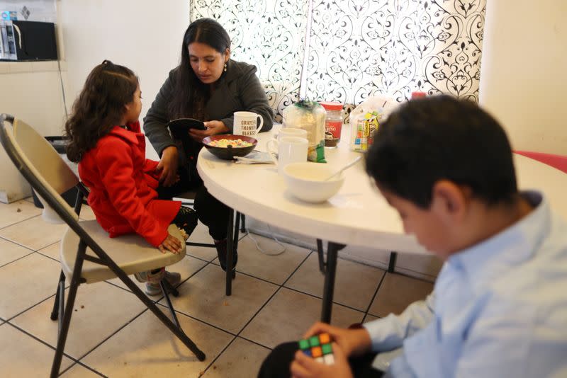 Emiliana, 32, eats breakfast with her son, Leonardo, 10, and daughter, Emily, 5, at their apartment in Los Angeles