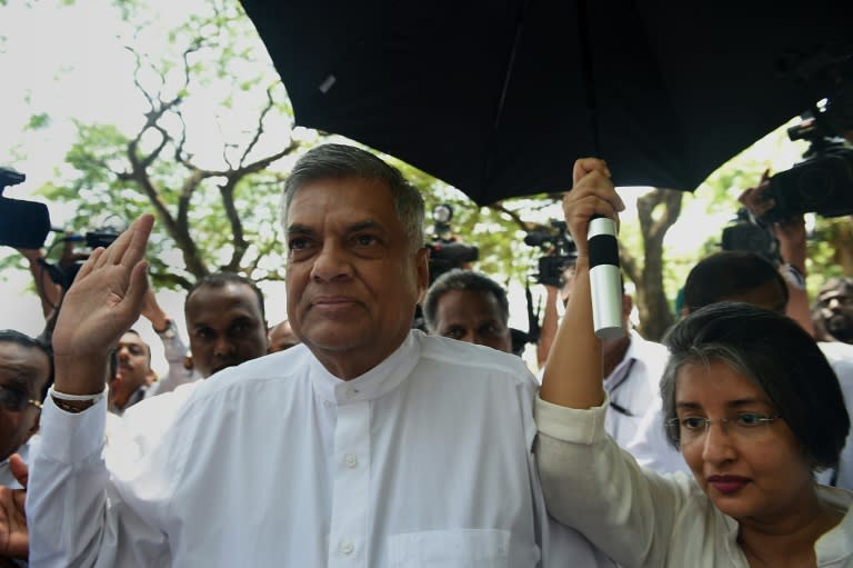 Sri Lanka's Prime Minister Ranil Wickremesinghe (L) and his wife Maithree Wickramasinghe arrive to cast their votes at a polling station in Colombo on August 17, 2015