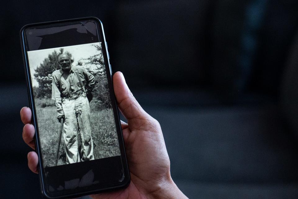 Candice Hammons shows a photo of Sterling Arnwine, inside her home in Peoria on Feb. 14, 2024.