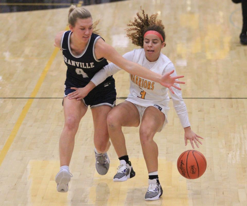 Granville's Taylor Warehime, left, defends Watkins Memorial's Jaylyn Thornton on Dec. 1.