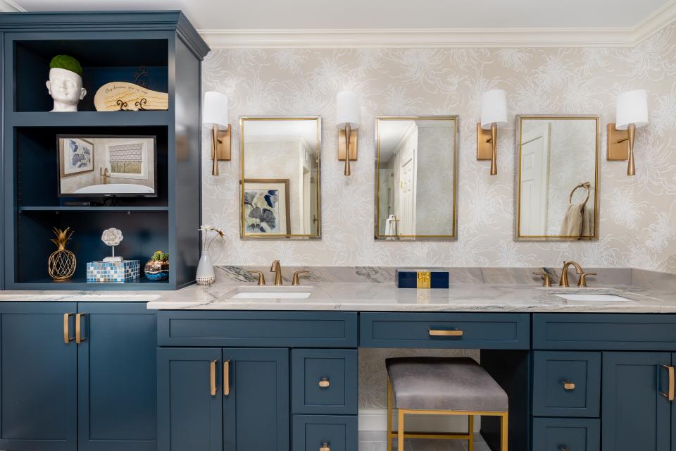 The refreshed space boasts new quartzite countertops, three separate vanity mirrors, and four updated sconces.