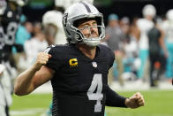 Las Vegas Raiders quarterback Derek Carr (4) celebrates after wide receiver Hunter Renfrow scored a touchdown against the Miami Dolphins during the second half of an NFL football game, Sunday, Sept. 26, 2021, in Las Vegas. (AP Photo/Rick Scuteri)