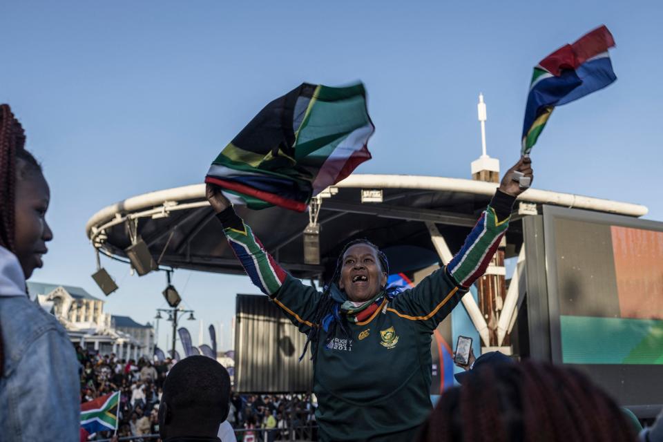 A South African supporter waves flags among fans gathering at the V&A Waterfront Mall in Cape Town (AFP via Getty Images)