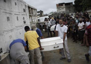 Alexsandro dos Santos, right center, carries the coffin containing the remains of his 4-year-old daughter Emily Victoria Silva dos Santos, at a cemetery in Duque de Caxias, Rio de Janeiro state, Brazil, Saturday, Dec. 5, 2020. Grieving families held funerals for Emily and her 7-year-old cousin Rebeca Beatriz Rodrigues dos Santos, killed by bullets while playing outside their homes. Weeping and cries of “justice” were heard Saturday at their funerals, reflecting the families’ assertion that the children were killed by police bullets. (AP Photo/Silvia Izquierdo)