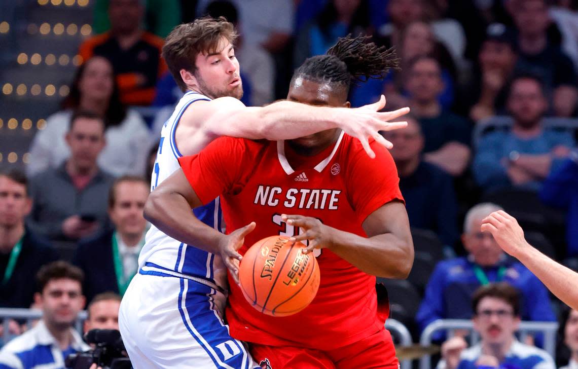Duke’s Ryan Young (15) defends N.C. State’s DJ Burns Jr. (30) during the first half of N.C. State’s game against Duke in the quarterfinal round of the 2024 ACC Men’s Basketball Tournament at Capital One Arena in Washington, D.C., Thursday, March 14, 2024.