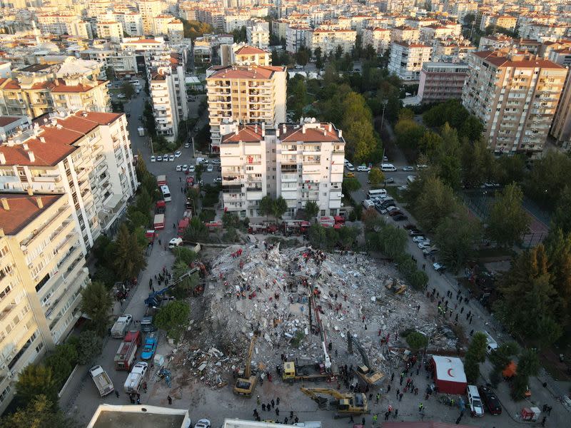 An aerial view shows rescue workers searching for survivors at a collapsed building after an earthquake in Izmir