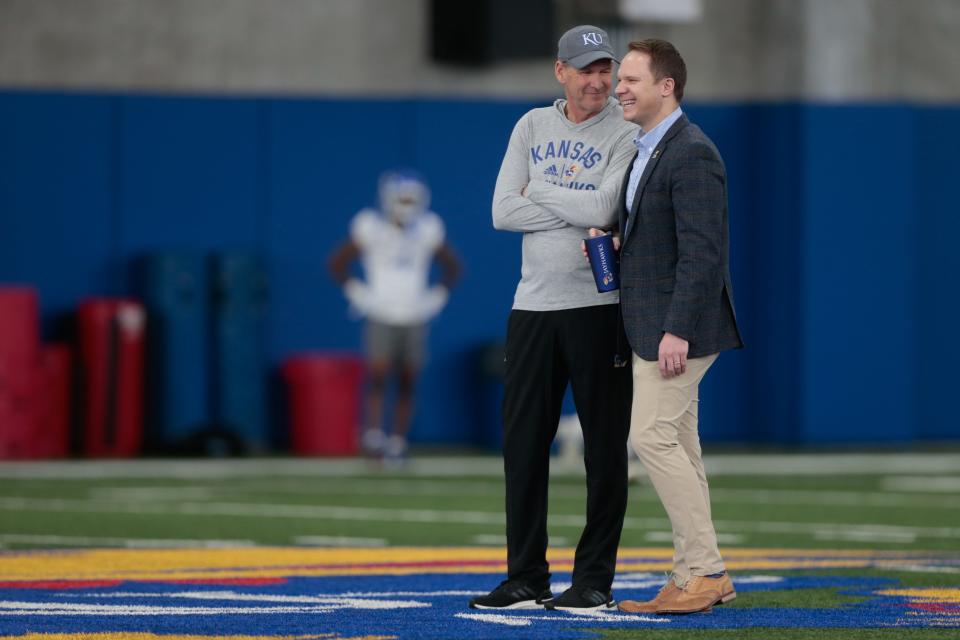 Kansas athletic director Travis Goff, right, chats with head football coach Lance Leipold during a spring practice earlier this year in Lawrence.