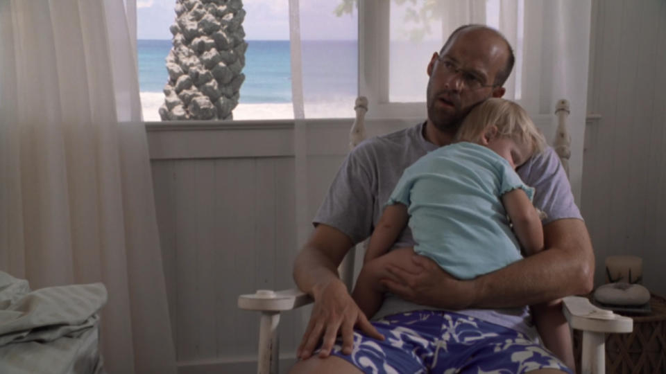 Anthony Edwards sings to a child in a rocking chair in ER.