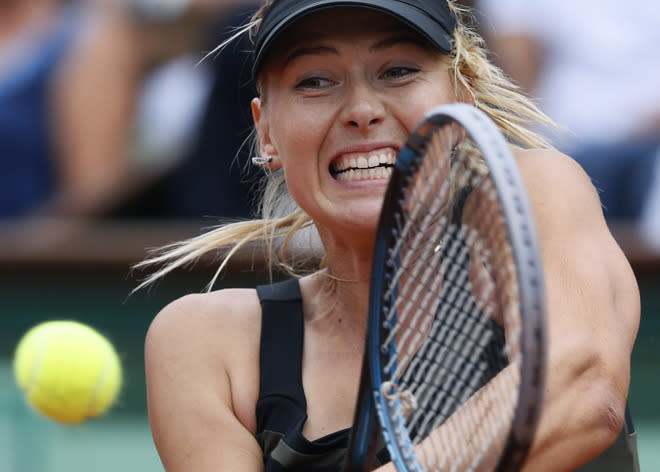 Russia's Maria Sharapova hits a return to Italy's Sara Errani during their Women's Singles final tennis match of the French Open tennis tournament at the Roland Garros stadium, on June 9, 2012 in Paris. AFP PHOTO / PATRICK KOVARIKPATRICK KOVARIK/AFP/GettyImages