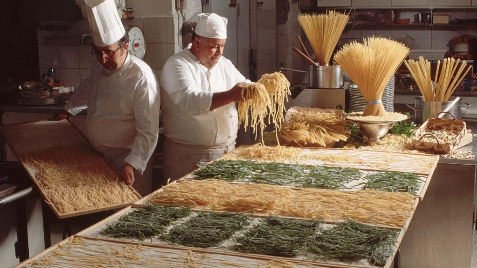 chefs prepare spaghetti