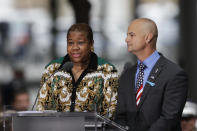 FILE - In this Sept. 11, 2018, file photo, La-Shawn Clark, left, and Mark Cannizzaro read names of victims of the Sept. 11 attacks during a ceremony marking the 17th anniversary in New York. Clark lost her husband, Benjamin Clark, and Cannizzaro lost his cousin, Brian Cannizzaro. The coronavirus pandemic has reshaped how the U.S. is observing the anniversary of 9/11. The terror attacks' 19th anniversary will be marked Friday, Sept. 11, 2020, by dueling ceremonies at the Sept. 11 memorial plaza and a corner nearby in New York. (AP Photo/Mark Lennihan, File)