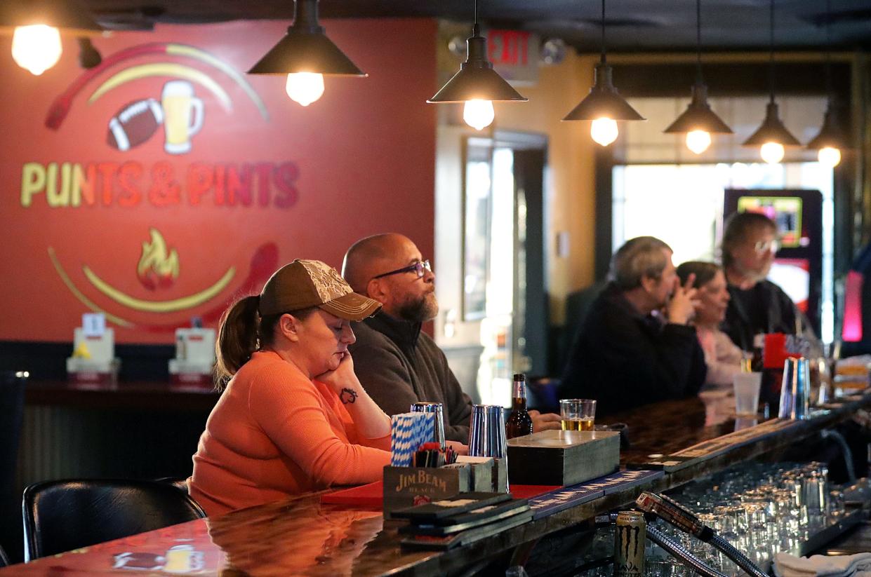 Customers enjoy a beverage at Punts & Pints, Tuesday, Dec. 13, 2022, in Cuyahoga Falls, Ohio.