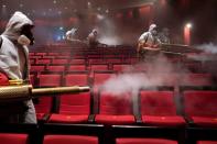 Volunteers from the Blue Sky Rescue team disinfect at the Qintai Grand Theatre in Wuhan