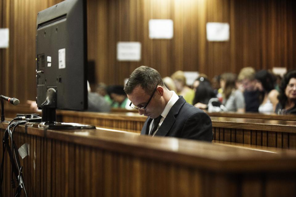 Oscar Pistorius sits in the dock in court in Pretoria, South Africa, Wednesday, May 14, 2014, as the judge overseeing his murder trial ordered him to undergo psychiatric tests, meaning that the trial proceedings will be delayed. The court adjourned until May 21, 2014. Pistorius is charged with murder for the shooting death of his girlfriend Reeva Steenkamp on Valentine's Day in 2013. (AP Photo/Gianluigi Guercia, Pool)