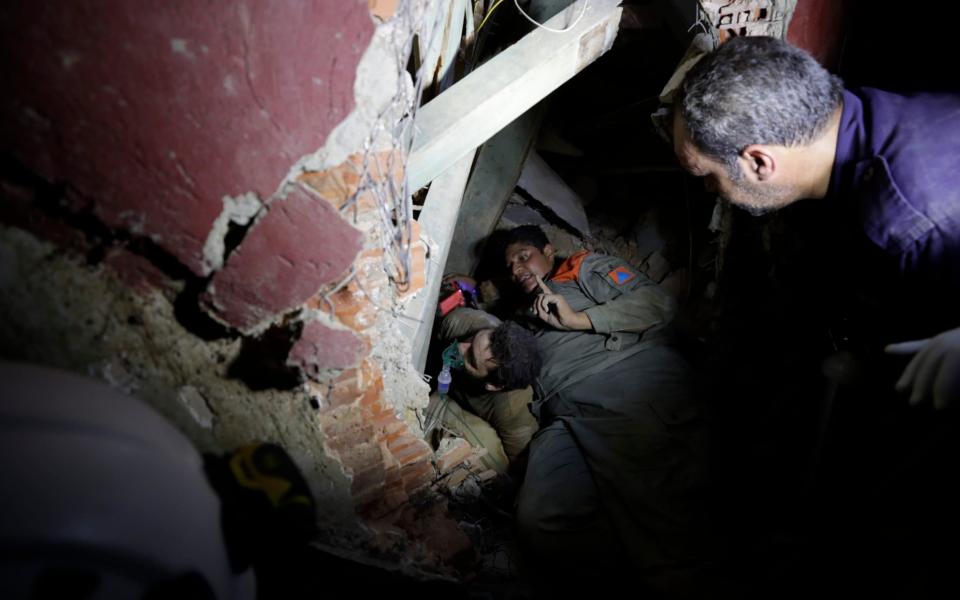 Lebanese soldiers search for survivors underneath the rubble - Hassan Ammar  /AP