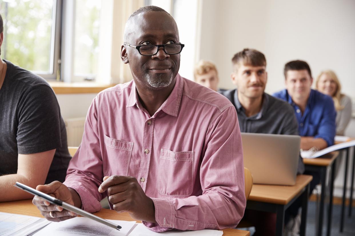 mature student using digital tablet in adult education class