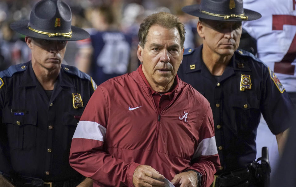 FILE - In this Nov. 30, 2020, file photo, Alabama head coach Nick Saban walks off the field after losing to Auburn in an NCAA college football game in Auburn, Ala. The mid-week news that Alabama coach Nick Saban tested positive for COVID-19 added a challenging backdrop for the season’s first Top 5 matchup. Saban figures to be communicating his marching orders and input from home while offensive coordinator Steve Sarkisian is manning the show within the football building. (Chris Shimek/The Decatur Daily via AP, File)