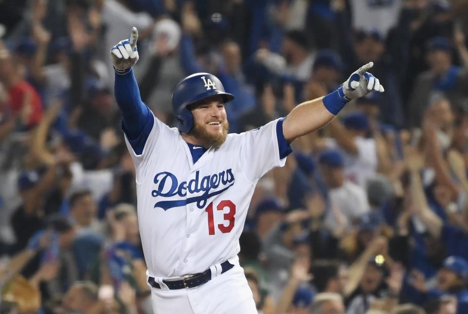 Max Muncy #13 of the Los Angeles Dodgers celebrates his 18th-inning walk-off home run to defeat the Boston Red Sox 3-2 in Game 3 of the 2018 World Series.