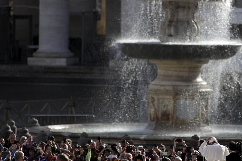 Pope Francis holds his skull cap as he arrives for his weekly general audience in St. Peter's Square at the Vatican, Wednesday, Nov. 7, 2018. (AP Photo/Gregorio Borgia)