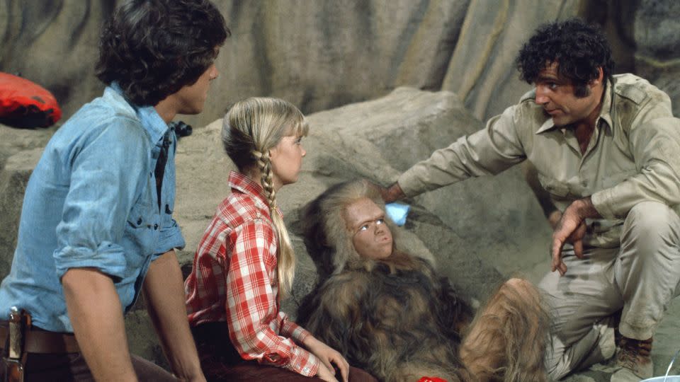 Wesley Eure as Will Marshall (left), Kathy Coleman as Holly Marshall (second-left), Philip Paley as Cha-Ka (second-right) and Spencer Milligan as Rick Marshall in "Land of the Lost." - Ron Tom/NBCU Photo Bank/Getty Images
