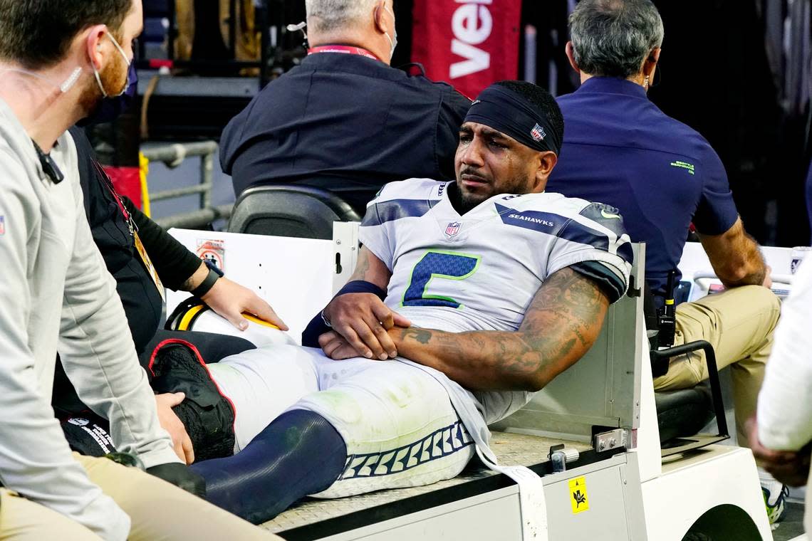 An injured Seattle Seahawks free safety Quandre Diggs is carted off the field during the second half of an NFL football game against the Arizona Cardinals Sunday, Jan. 9, 2022, in Glendale, Ariz. (AP Photo/Darryl Webb)