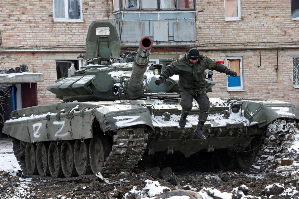 A Russian tank with the "Z" logo inscribed on it outside a residential building which was damaged during Ukraine-Russia conflict in the separatist-controlled town of Volnovakha in the Donetsk region, Ukraine March 11, 2022