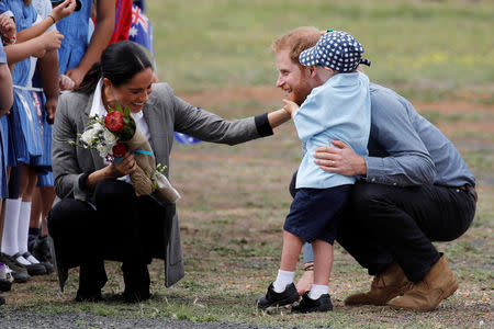 Britain's Prince Harry and Meghan, Duchess of Sussex, interact with Luke Vincent, 5, after arriving at Dubbo airport, Dubbo, Australia October 17, 2018. REUTERS/Phil Noble