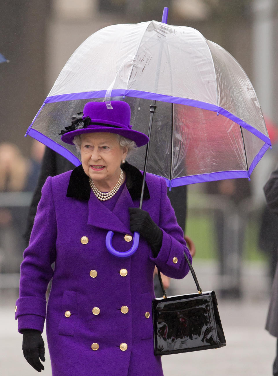 LONDON, UNITED KINGDOM - OCTOBER 25: (EMBARGOED FOR PUBLICATION IN UK NEWSPAPERS UNTIL 48 HOURS AFTER CREATE DATE AND TIME) Queen Elizabeth II shelters under an umbrella as attends the opening of the newly developed Jubilee Gardens on October 25, 2012 in London, England. (Photo by Indigo/Getty Images)