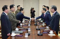 In this photo released by the South Korean Unification Ministry, South Korean chief delegate Kim Kyou-hyun, second from right, shakes hands with his North Korean counterpart Won Tong Yon, third from left, during their meeting at the border village of Panumjom, South Korea, Wednesday, Feb. 12, 2014. The senior officials from the rival Koreas met Wednesday at a border village, their highest-level talks in years and a potential signal that Pyongyang wants better ties and the resumption of lucrative cooperative projects.(AP Photo/South Korean Unification Ministry)