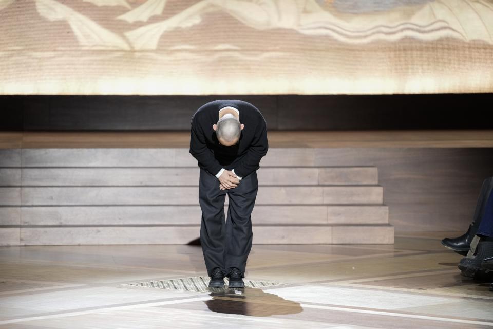 Designer Satoshi Kondo accepts applause after the Issey Miyake Fall/Winter 2024-2025 ready-to-wear collection presented Friday, March 1, 2024 in Paris. (Photo by Scott A Garfitt/Invision/AP)