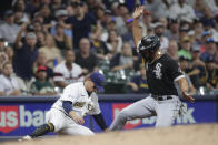 Chicago White Sox's Jose Abreu, right, slides in safely at third base past the tag of Milwaukee Brewers' Luis Urias during the sixth inning of a baseball game Friday, July 23, 2021, in Milwaukee. (AP Photo/Aaron Gash)