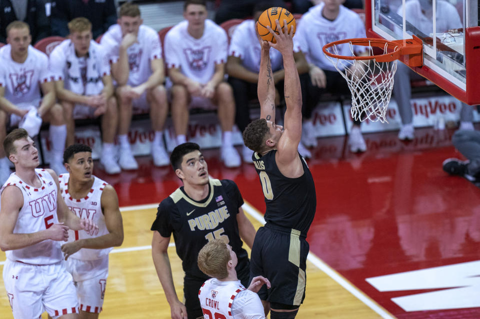 Purdue's Mason Gillis (0) dunks past Wisconsin's Steven Crowl (22) during the first half of an NCAA college basketball game Tuesday, March 1, 2022, in Madison, Wis. (AP Photo/Andy Manis)