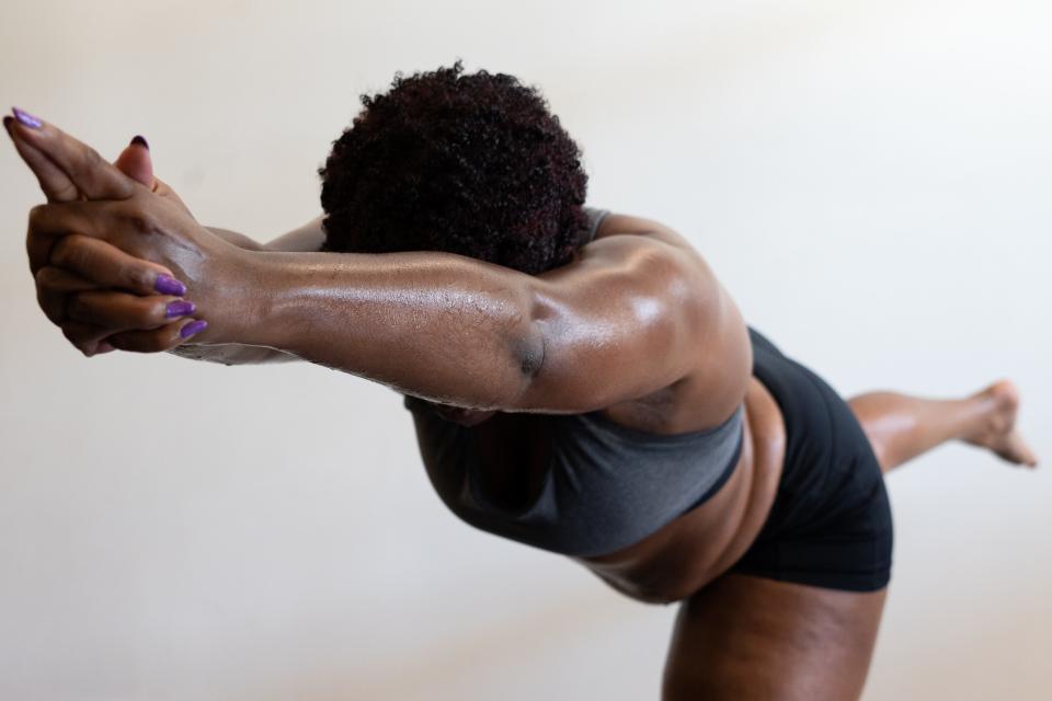 Joy Rogers holds a pose during a Hot Room yoga class called One Breath on Saturday, July 3. The class, new this year, is intended to be specifically for people of color as Indianapolis' yoga scene seeks to diversify.