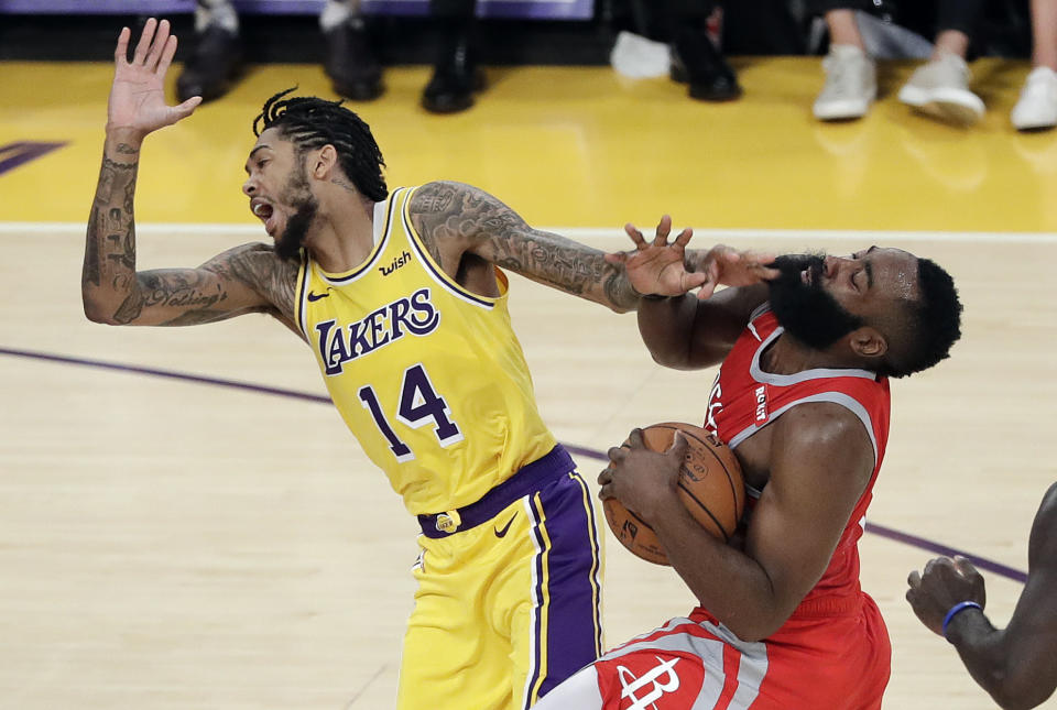 Houston Rockets' James Harden, right, collides with Los Angeles Lakers' Brandon Ingram (14) during the second half of an NBA basketball game Saturday, Oct. 20, 2018, in Los Angeles. (AP Photo/Marcio Jose Sanchez)