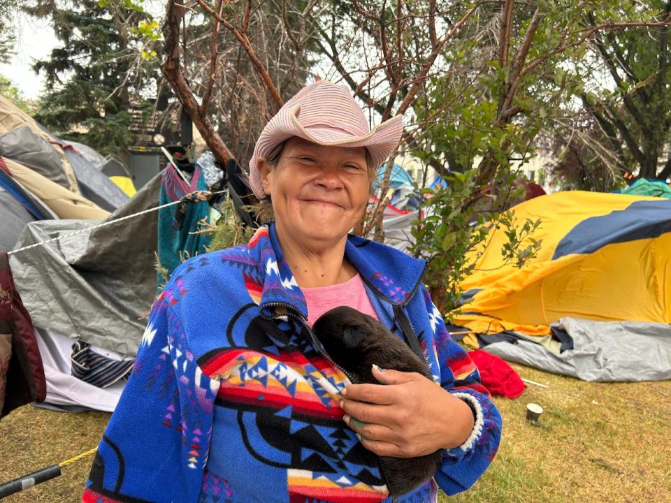 Dezaray Littletent and her puppy Mohawk live in the encampment in front of City Hall.