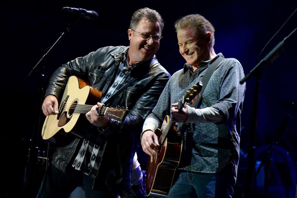 <p>Kevin Mazur/Getty</p> Vince Gil and Don Henley perform onstage with The Eagles during The Classic West at Dodger Stadium on July 15, 2017 in Los Angeles, California