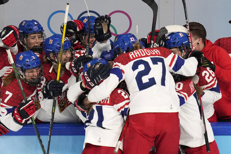 Czech Republic's Michaela Pejzlova (18) celebrates her goal with teammates during a women's quarterfinal hockey game against United States at the 2022 Winter Olympics, Friday, Feb. 11, 2022, in Beijing. (AP Photo/Petr David Josek)