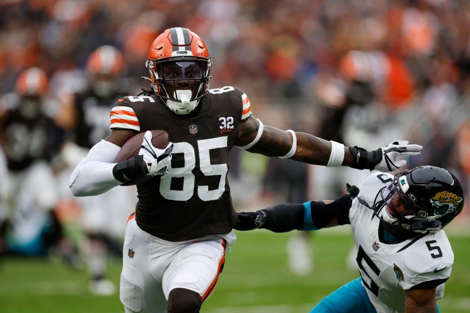 Cleveland Browns tight end David Njoku stiff arms Jacksonville Jaguars safety Andre Cisco (5) during the first half Sunday in Cleveland.