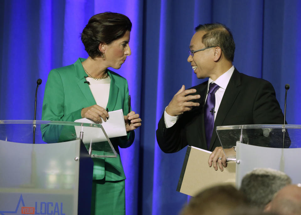 Rhode Island gubernatorial candidates Democratic Gov. Gina Raimondo, left, and Republican Cranston Mayor Allan Fung, right, speak at the conclusion of a televised debate Thursday, Sept. 27, 2018, in Bristol, R.I. (AP Photo/Steven Senne)