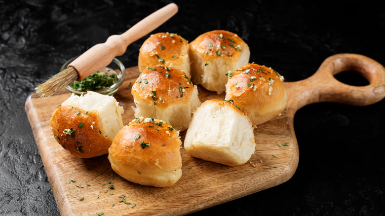 homemade bread rolls on cutting board