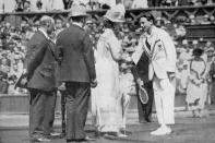 <p>Jean Boratra receives his medal from Queen Mary.</p>