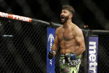 Andrei Arlovski celebrates after defeating Travis Browne at UFC 187. (AP)